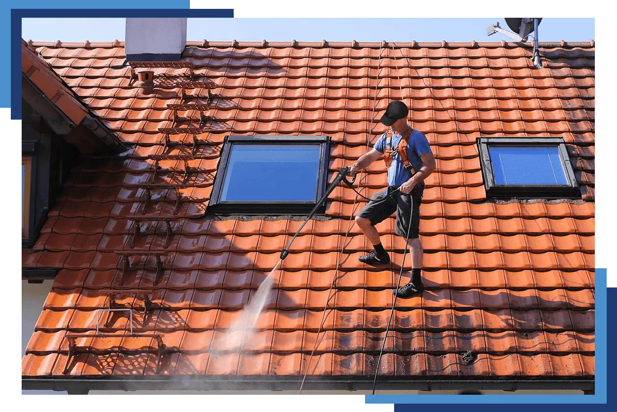 A man is cleaning the roof of a house